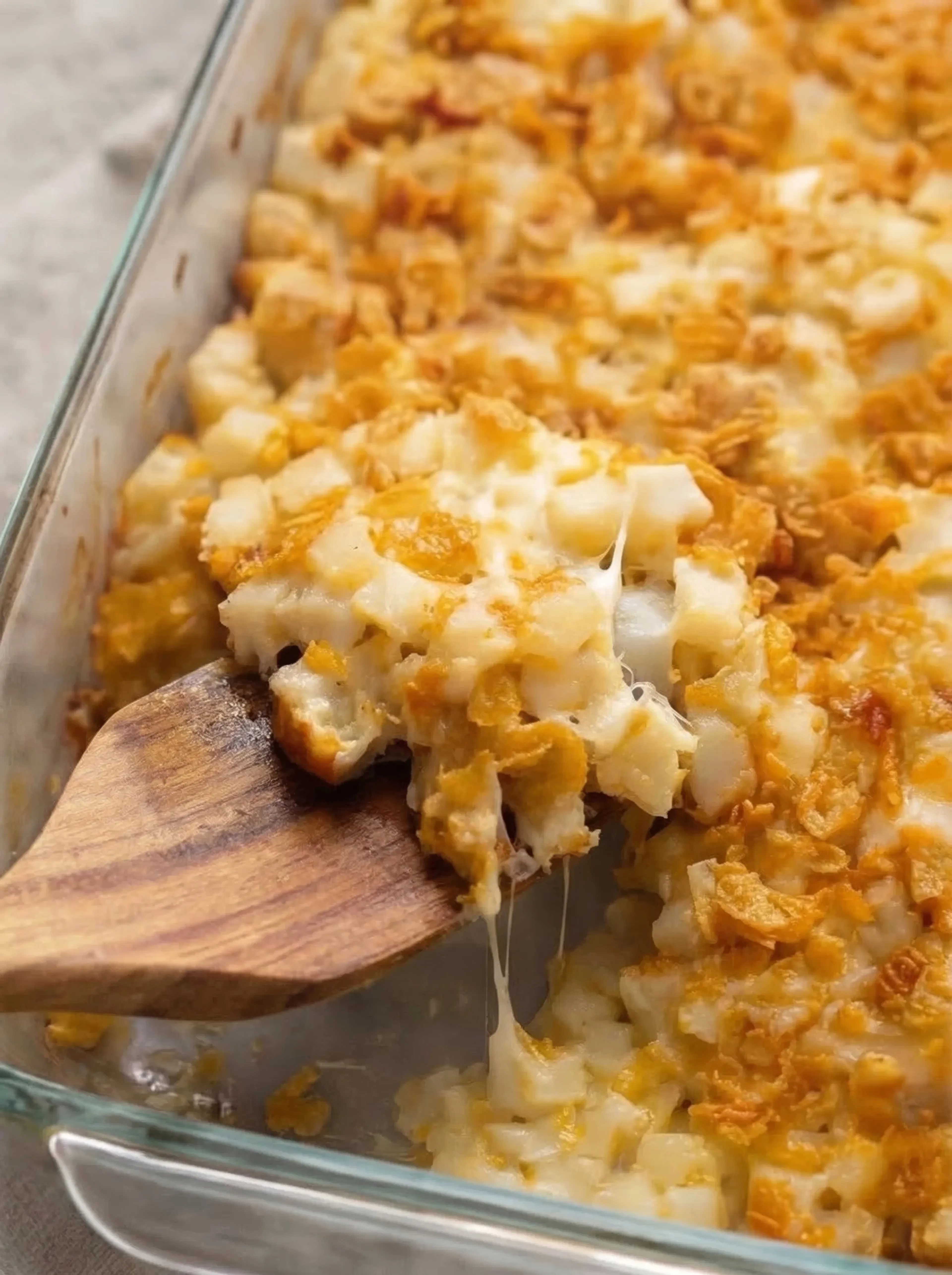 Close-up of creamy potatoes with melted cheese and crispy cornflake topping