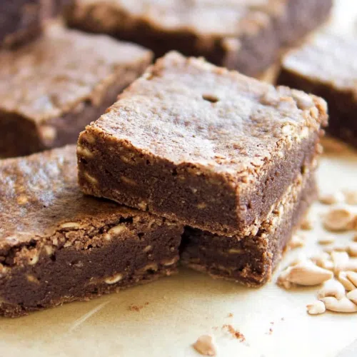 Golden-brown muffins with a slightly cracked, domed top.