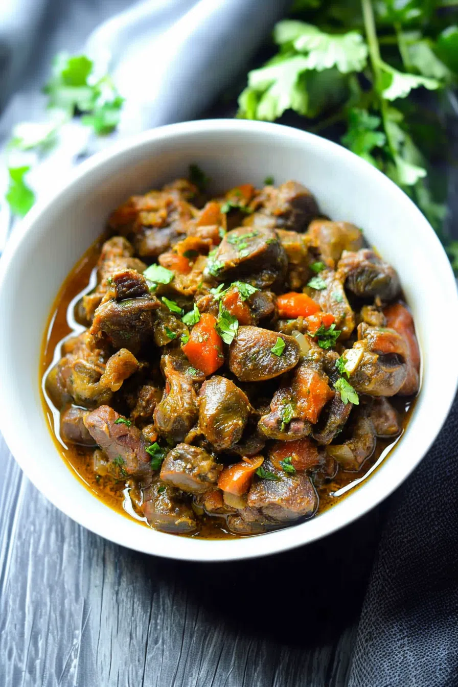 Braised chicken hearts and gizzards arranged beautifully on a platter, showcasing their succulent texture.
