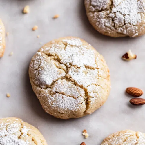 Close-up of a cracked cookie revealing a soft, spiced interior.
