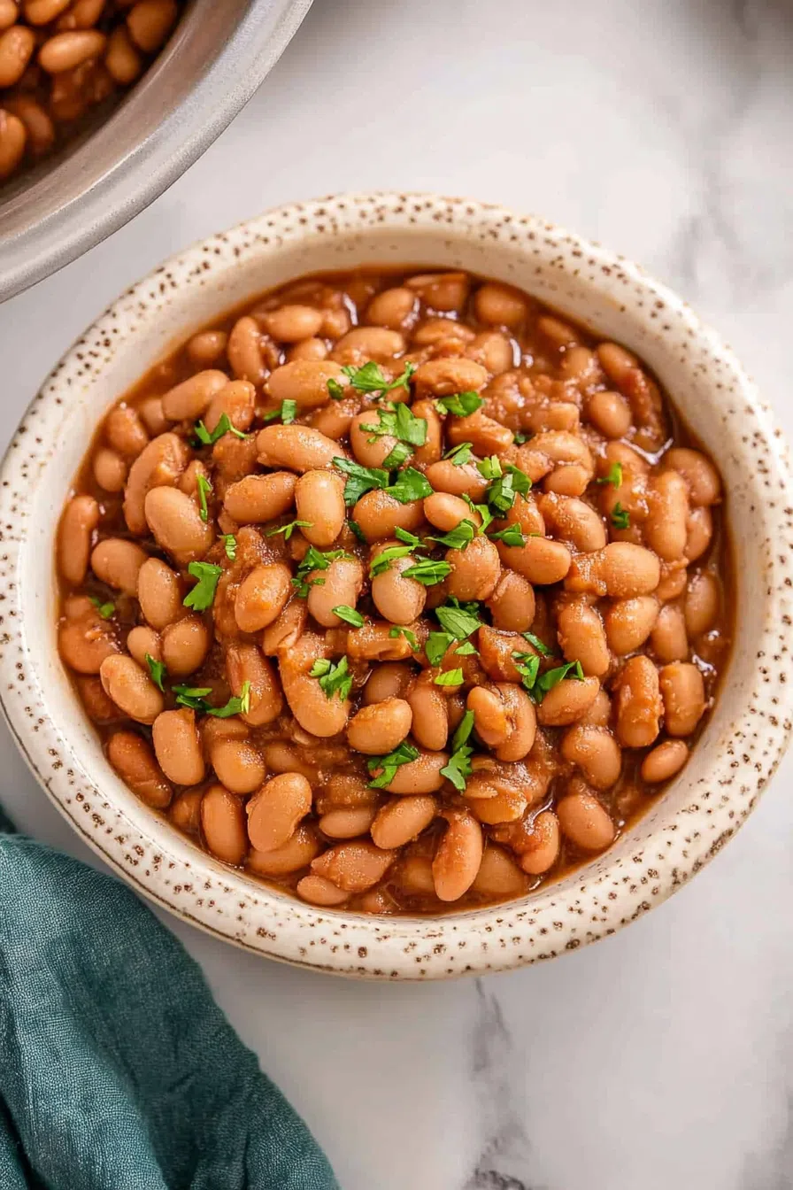 Pinto beans served in a rustic dish with fresh cilantro on top.