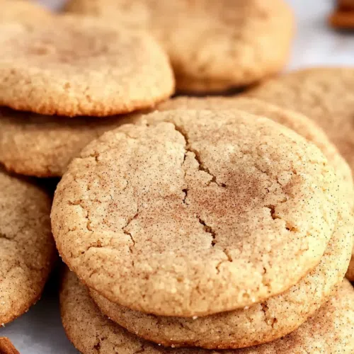 A close-up of freshly baked cookies with cracked tops, revealing a soft interior.