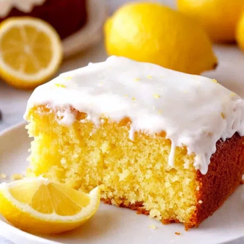 Sliced cake pieces arranged neatly on a white plate with glaze glistening on top.