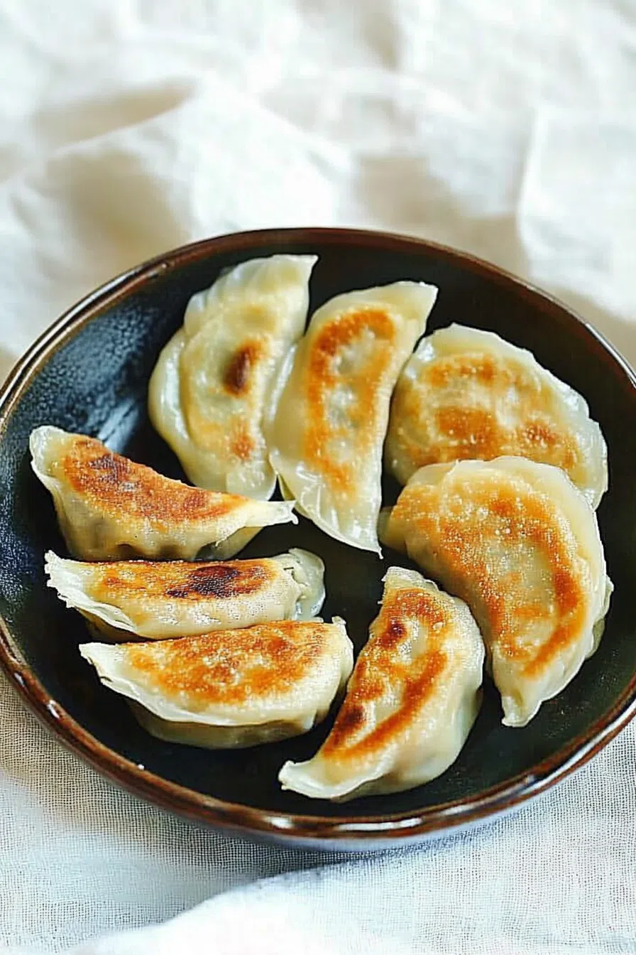Pan-fried dumplings with a crispy bottom and soft top.