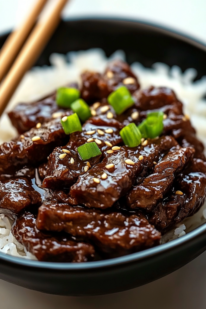 Chopsticks resting on the side of a full dinner bowl.