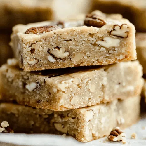 Stack of buttery cookies tied with twine, resting on a marble surface.