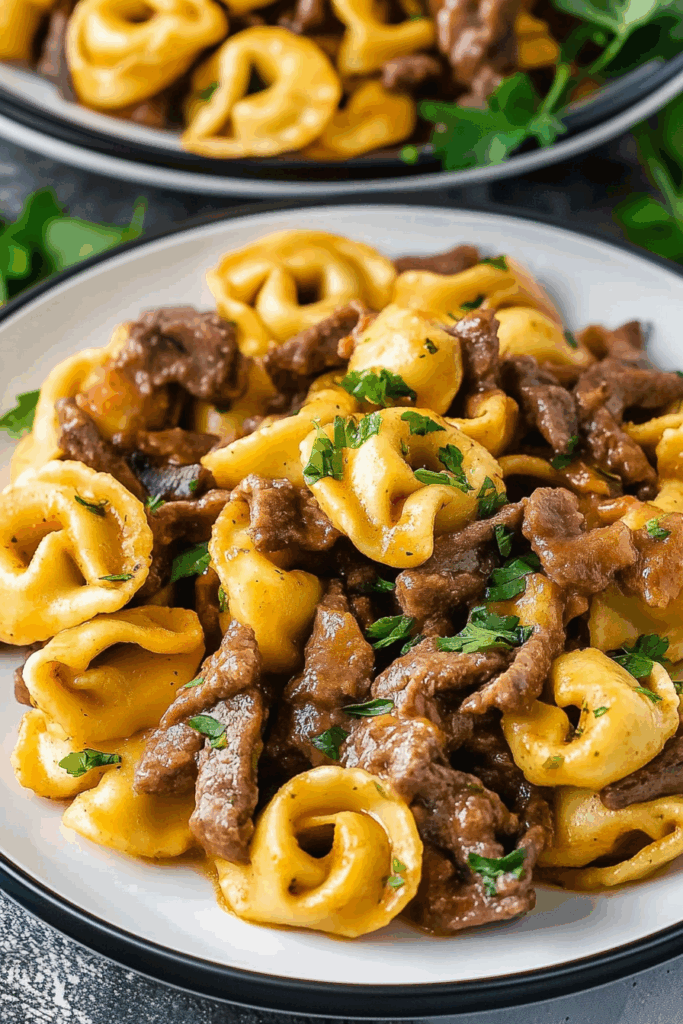 Hearty comfort food plated with sautéed onions and bell peppers for a pop of color.