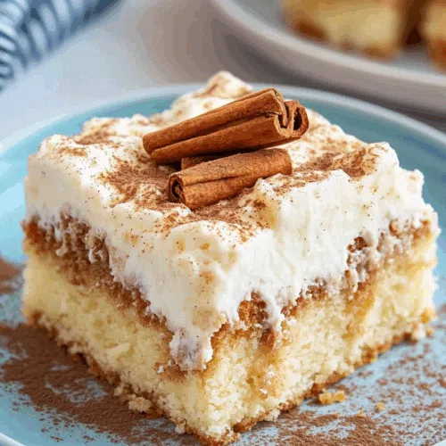 Sliced dessert topped with creamy icing and a swirl of cinnamon glaze.