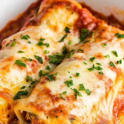 Close-up of a pasta roll sliced open to reveal the creamy ricotta filling