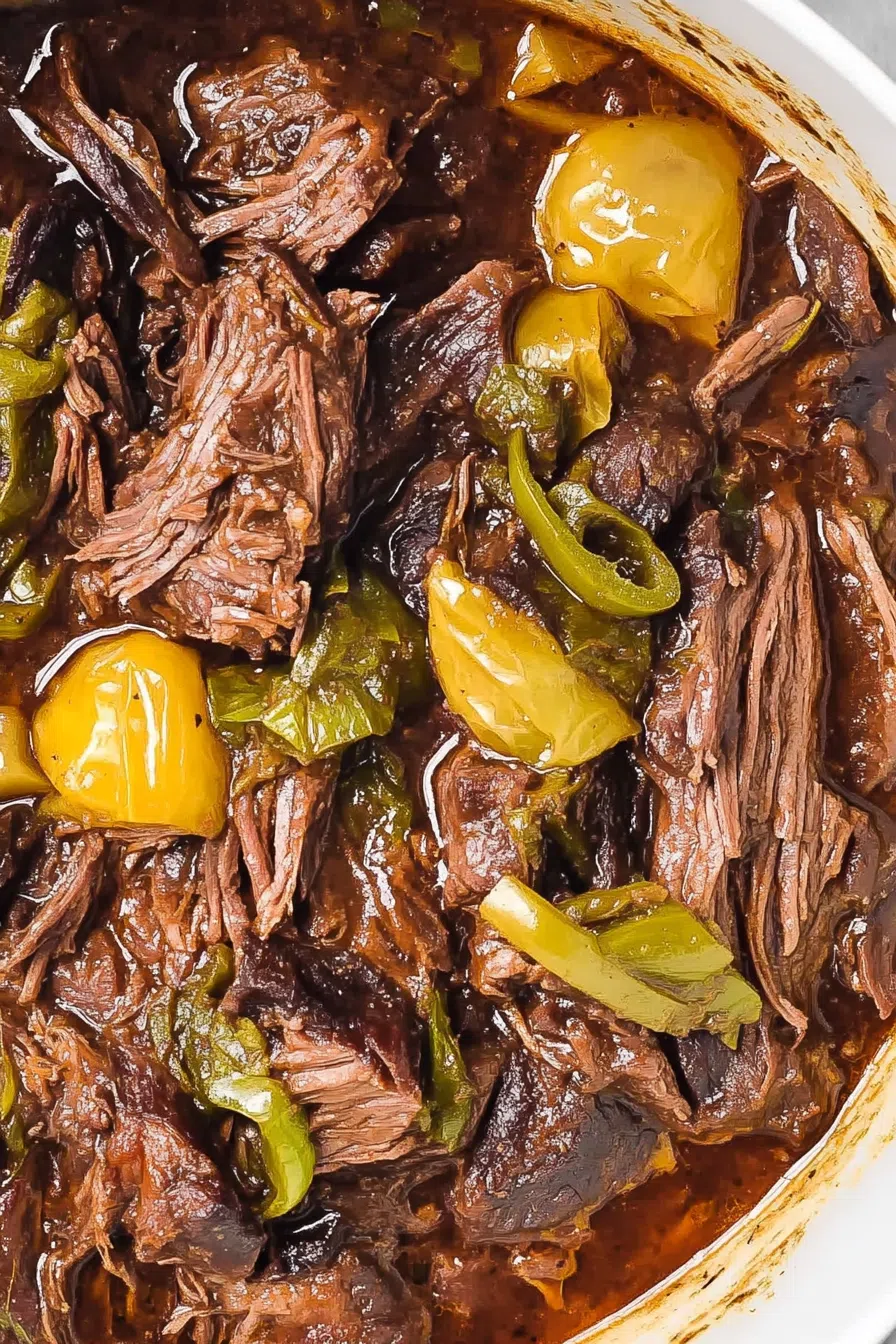 Close-up of slow-cooked meat on a rustic dinner plate.
