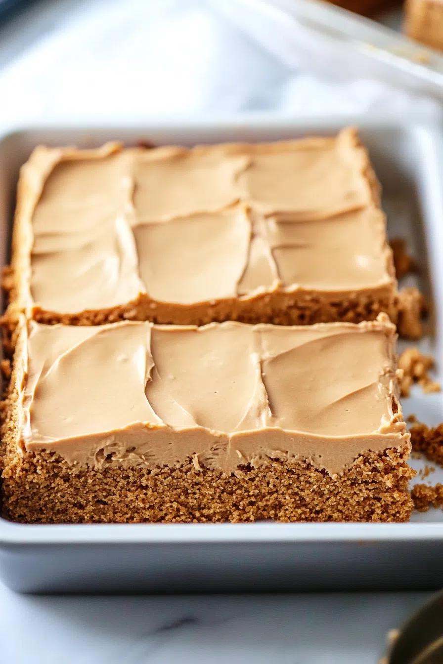 Close-up showing smooth peanut butter glaze over a moist cake.