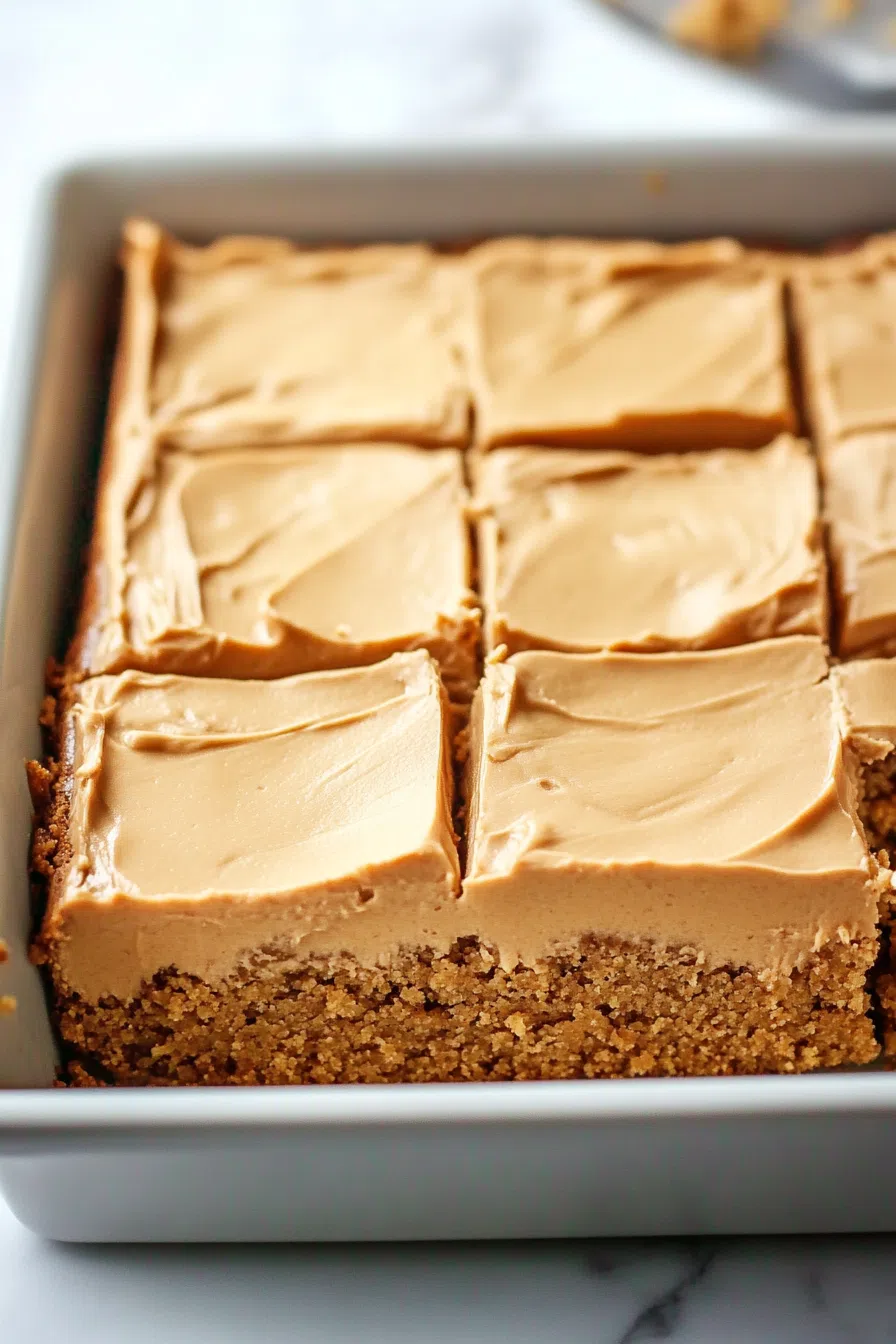 Overhead view of a sheet cake cut into generous squares.