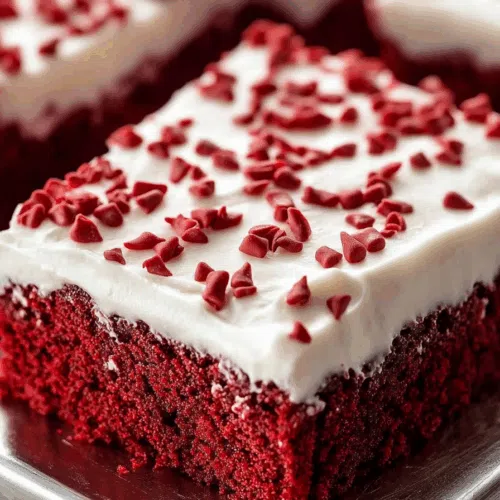 Close-up of a moist, rich cake with a fluffy frosting layer.