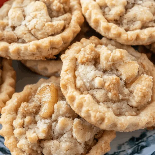 Soft, chewy cookies with a crispy topping shown in a cozy kitchen setting.