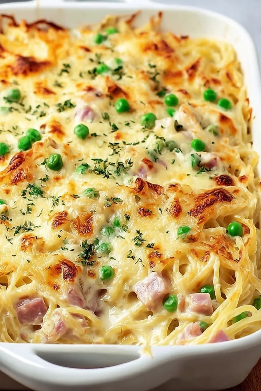 Baked pasta dish in a white casserole dish with golden, bubbly topping.