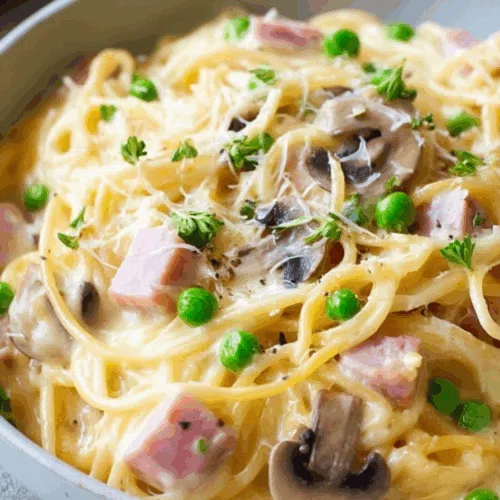 Close-up of a creamy noodle bake served on a rustic dinner plate.