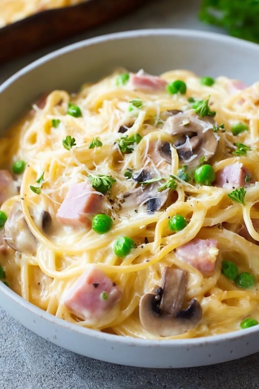Close-up of a creamy noodle bake served on a rustic dinner plate.