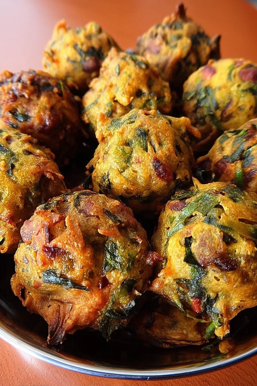 Close-up of a crispy snack broken open to reveal a vibrant green center.