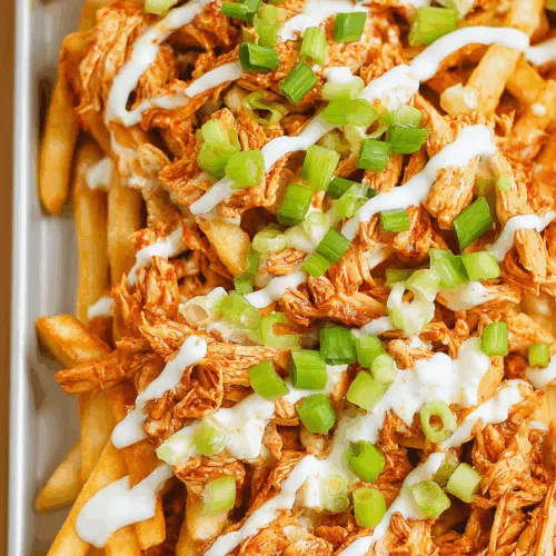 Close-up of spicy, saucy fries served in a rustic tray.