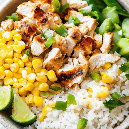 Close-up of a loaded bowl featuring charred vegetables and seasoned meat.