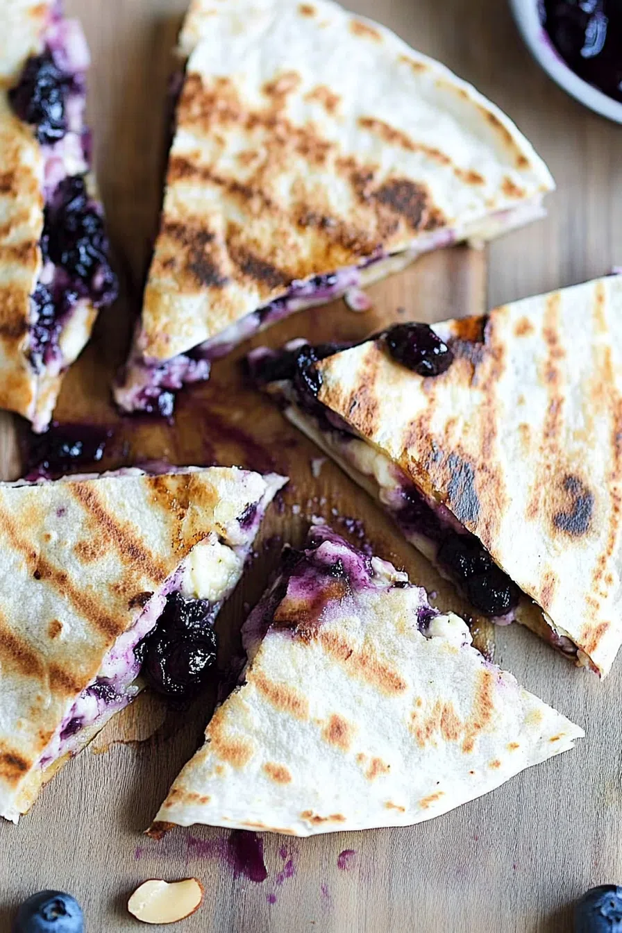 Crispy tortilla folded around warm fruit filling, lightly dusted with powdered sugar.