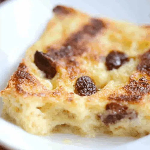 Comforting, oven-baked dish presented in a rustic white bowl with lightly toasted edges.