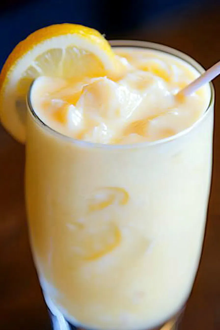 Close-up of an iced drink with creamy texture and bubbles.