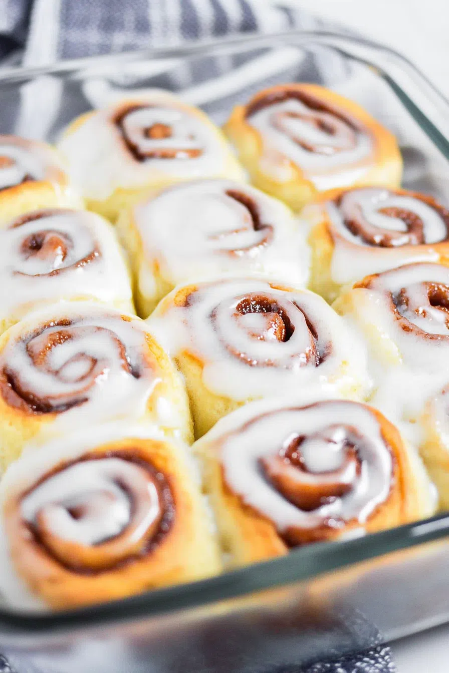 Overhead view of a cozy breakfast treat arranged in a baking dish with melted glaze