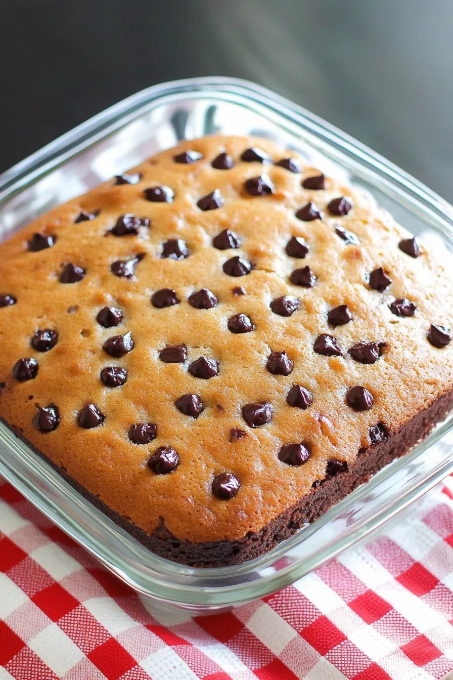 Overhead view of a freshly baked loaf with raisins peeking through the crumb.