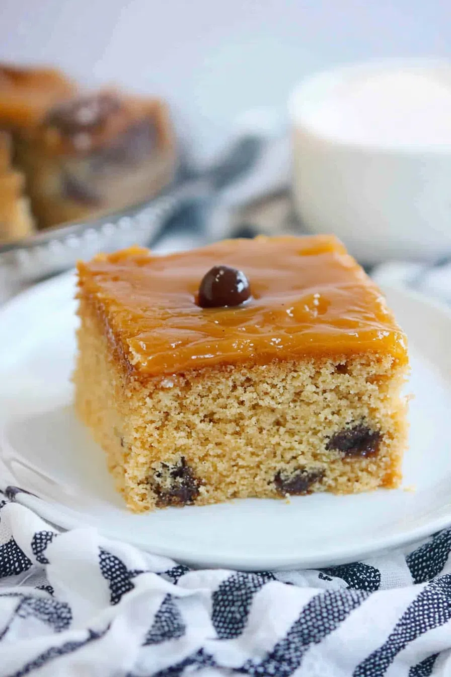 Soft, dense cake squares with a shiny glaze served on a white platter