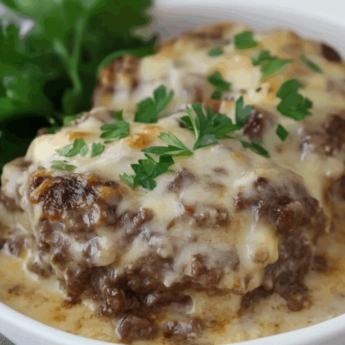 Comfort food dinner portion on a plate with mashed potatoes and herbs.
