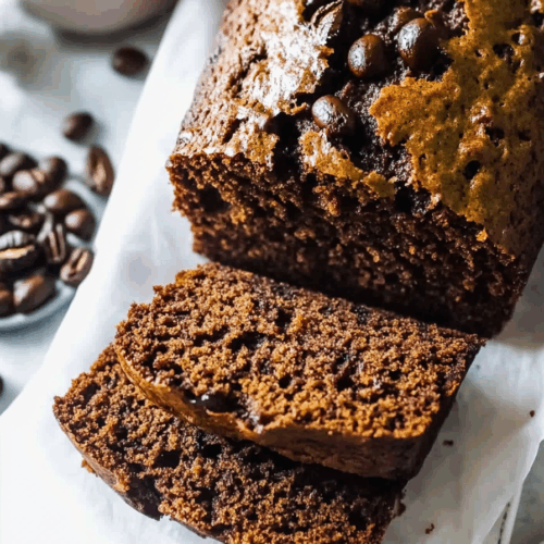 Close-up of a baked treat showing gooey chocolate and golden-brown edges.