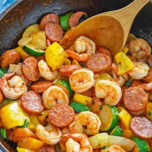 Colorful one-pan dish with seared proteins and sautéed vegetables