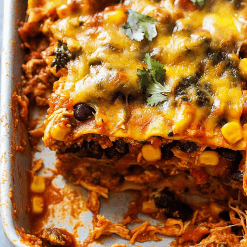 Hearty slice of a stacked savory bake showing layers of meat, sauce, and cheese