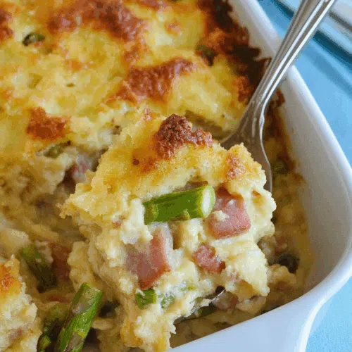 Close-up of a creamy, bubbly casserole fresh from the oven in a white baking dish.