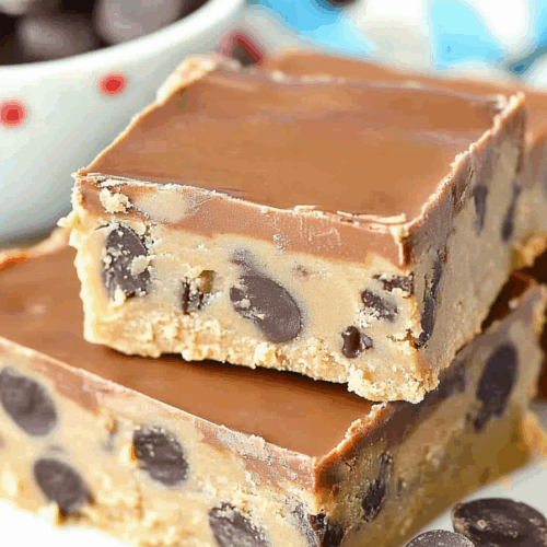 Layered dessert bars with a glossy caramel top and rich, dense base