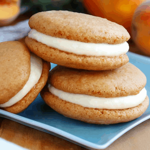 Golden cake-like rounds with piped filling peeking out from the edges