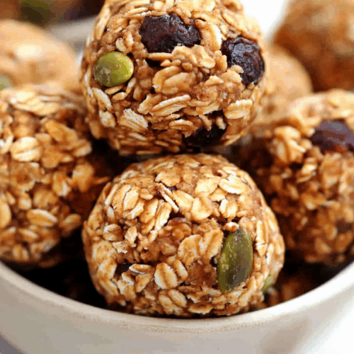 Round snack balls stacked in a small bowl.