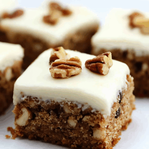Freshly frosted dessert bars with a sprinkle of toasted pecans.
