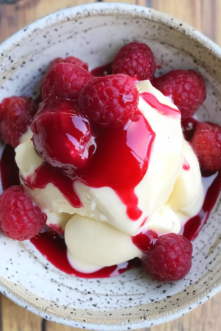 Bright sauce swirled artfully on a dessert plate