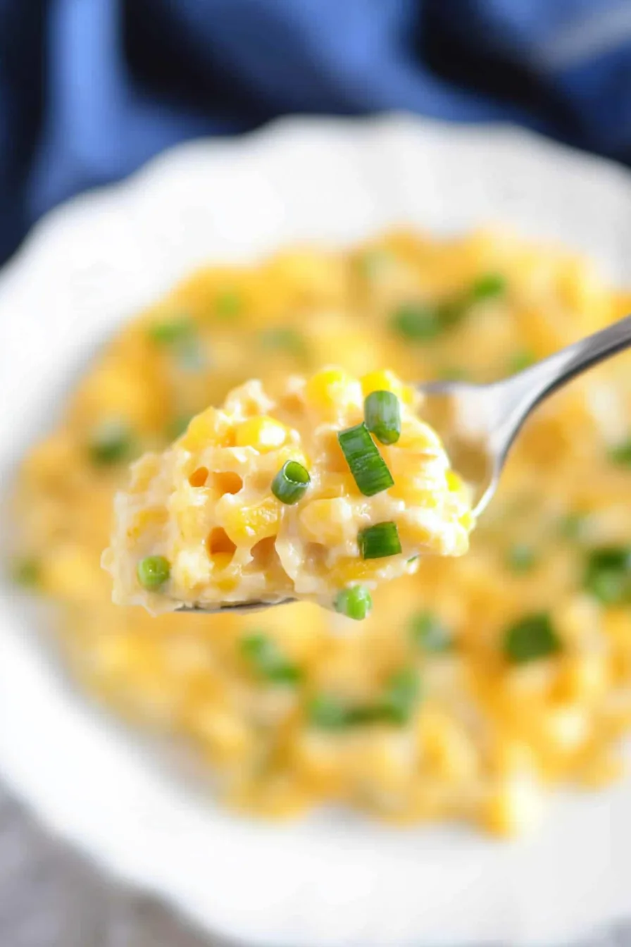 Spoonful of creamy, corn-filled casserole on a plate