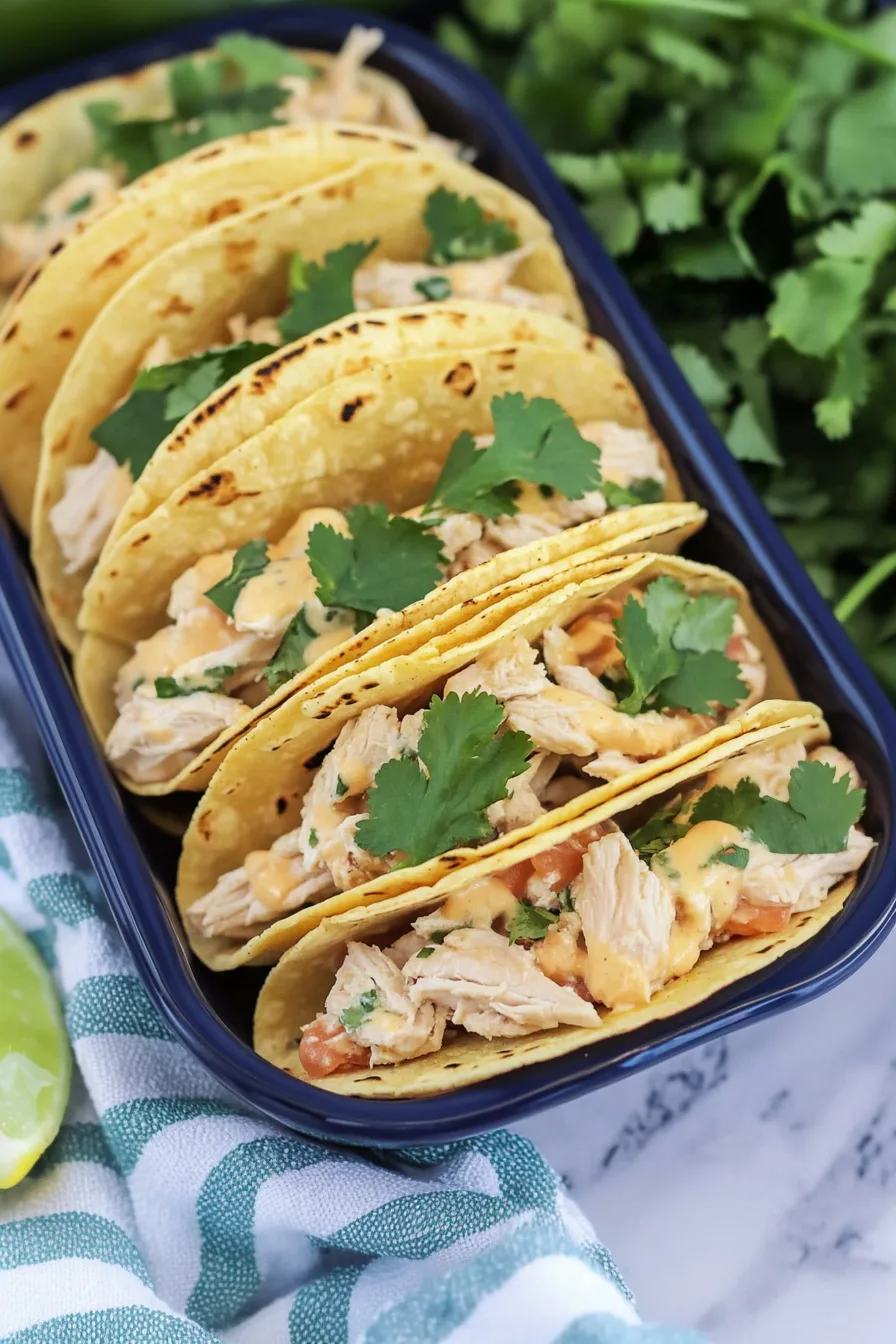 Cheesy, savory taco filling spilling out of soft flour tortillas