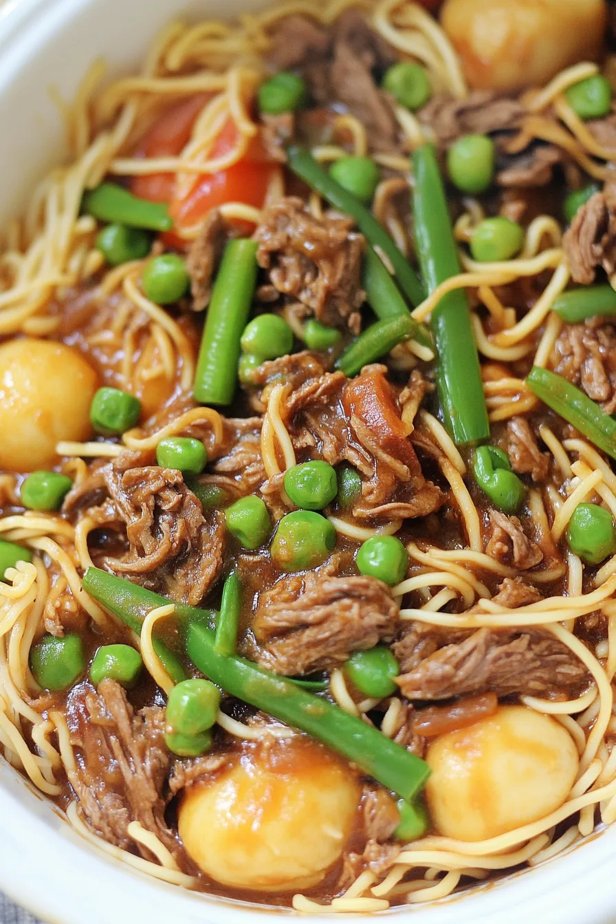 Close-up of saucy noodles garnished with sesame seeds and green onions.