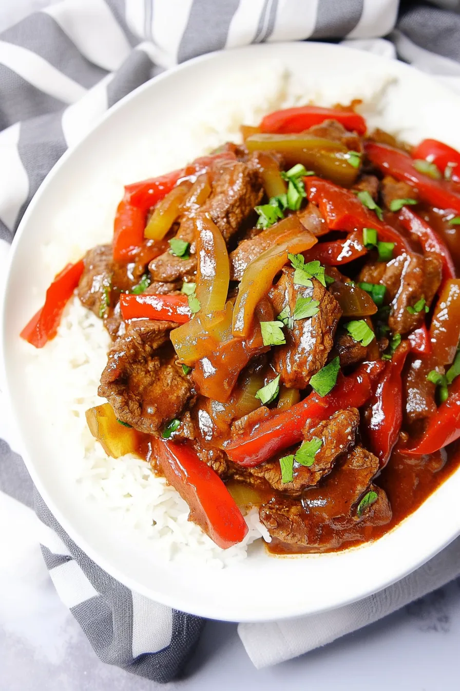 Family-style serving dish filled with slow-cooked steak and vegetables