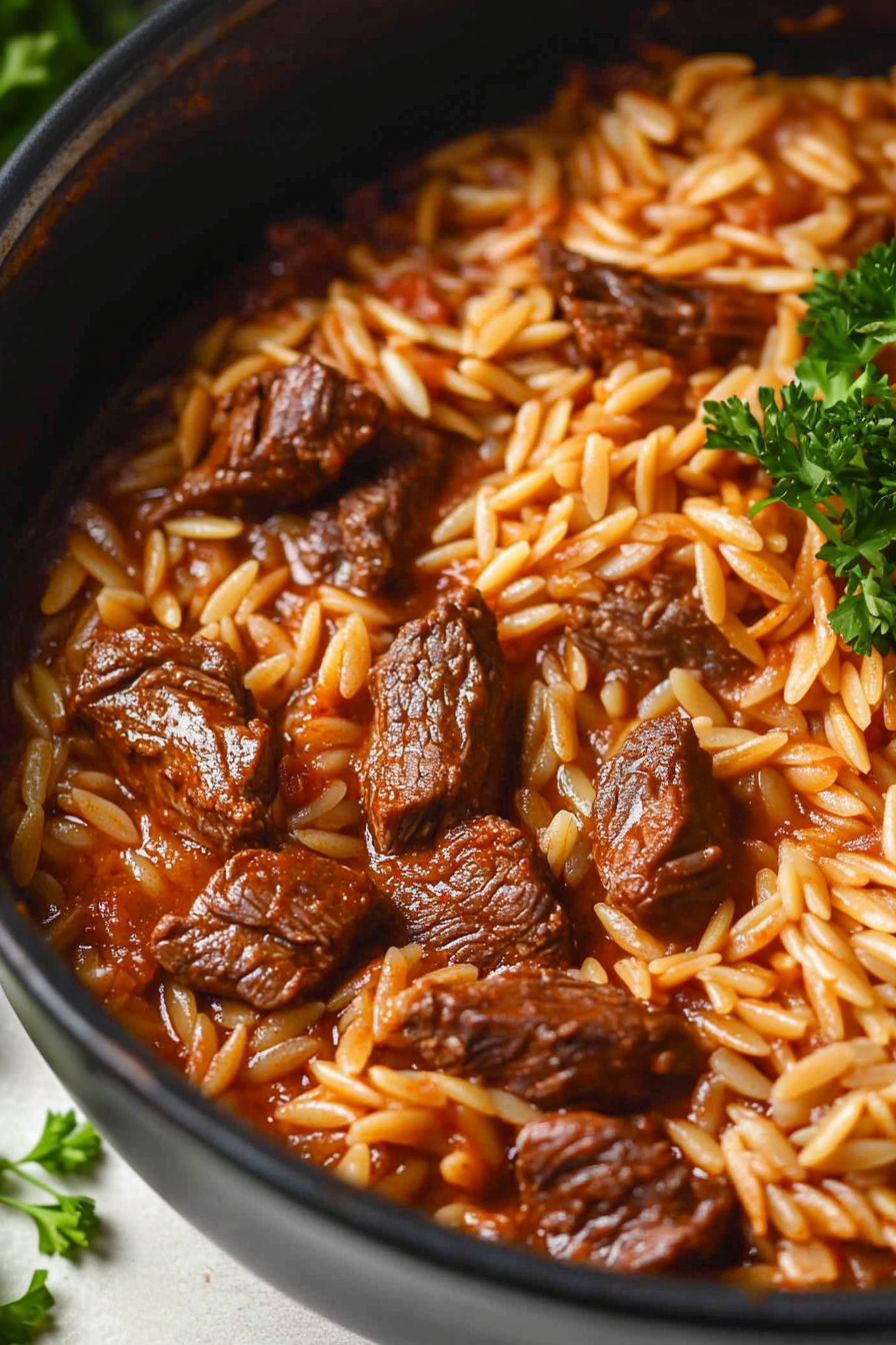 Oven-baked beef and orzo topped with fresh herbs