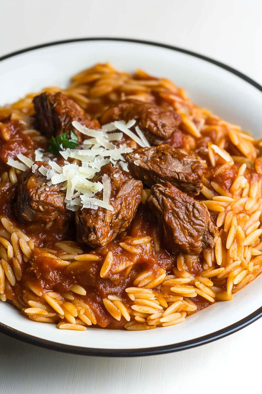Baked beef and orzo pasta served in a rustic dish