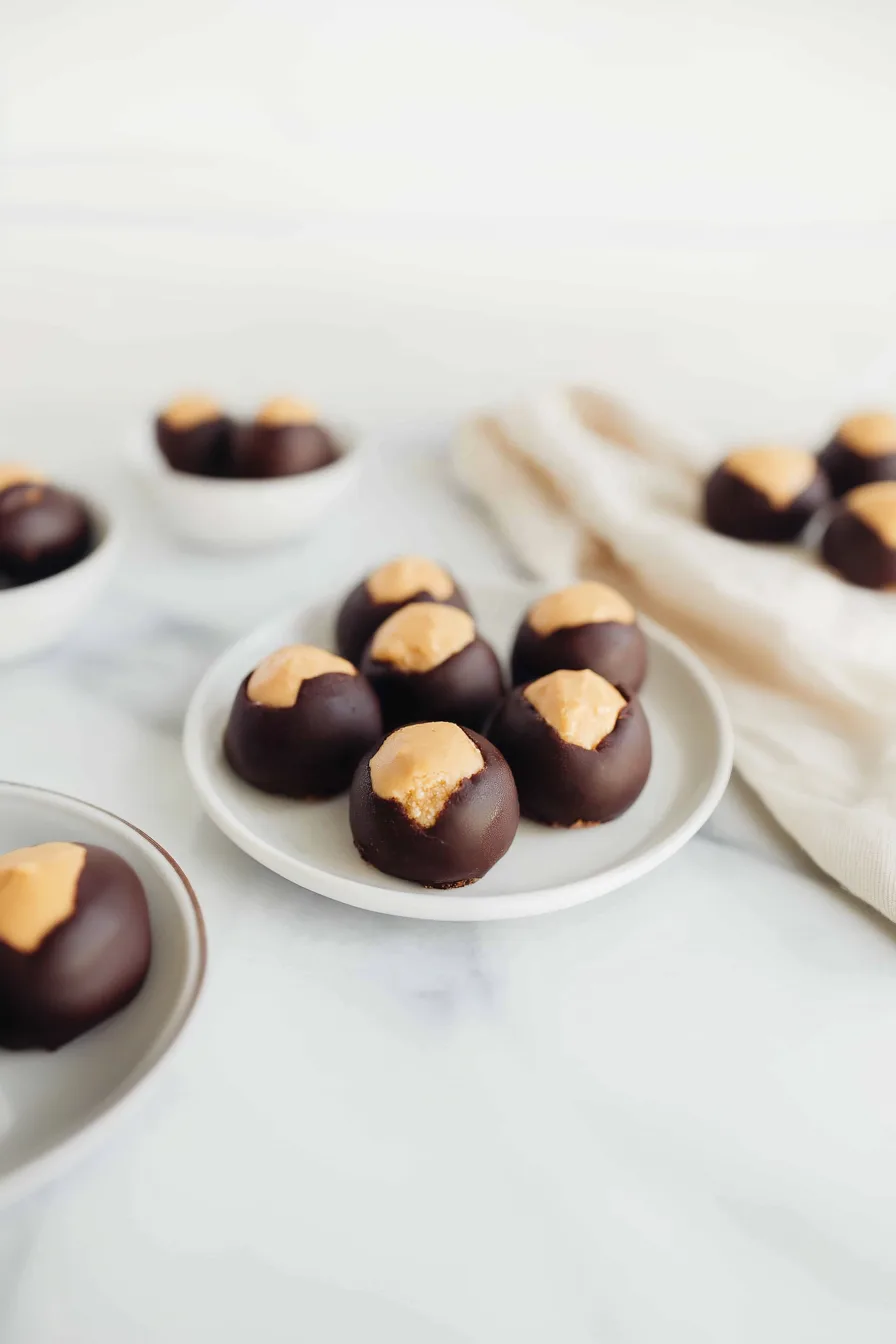 Plate filled with glossy chocolate-coated confections.