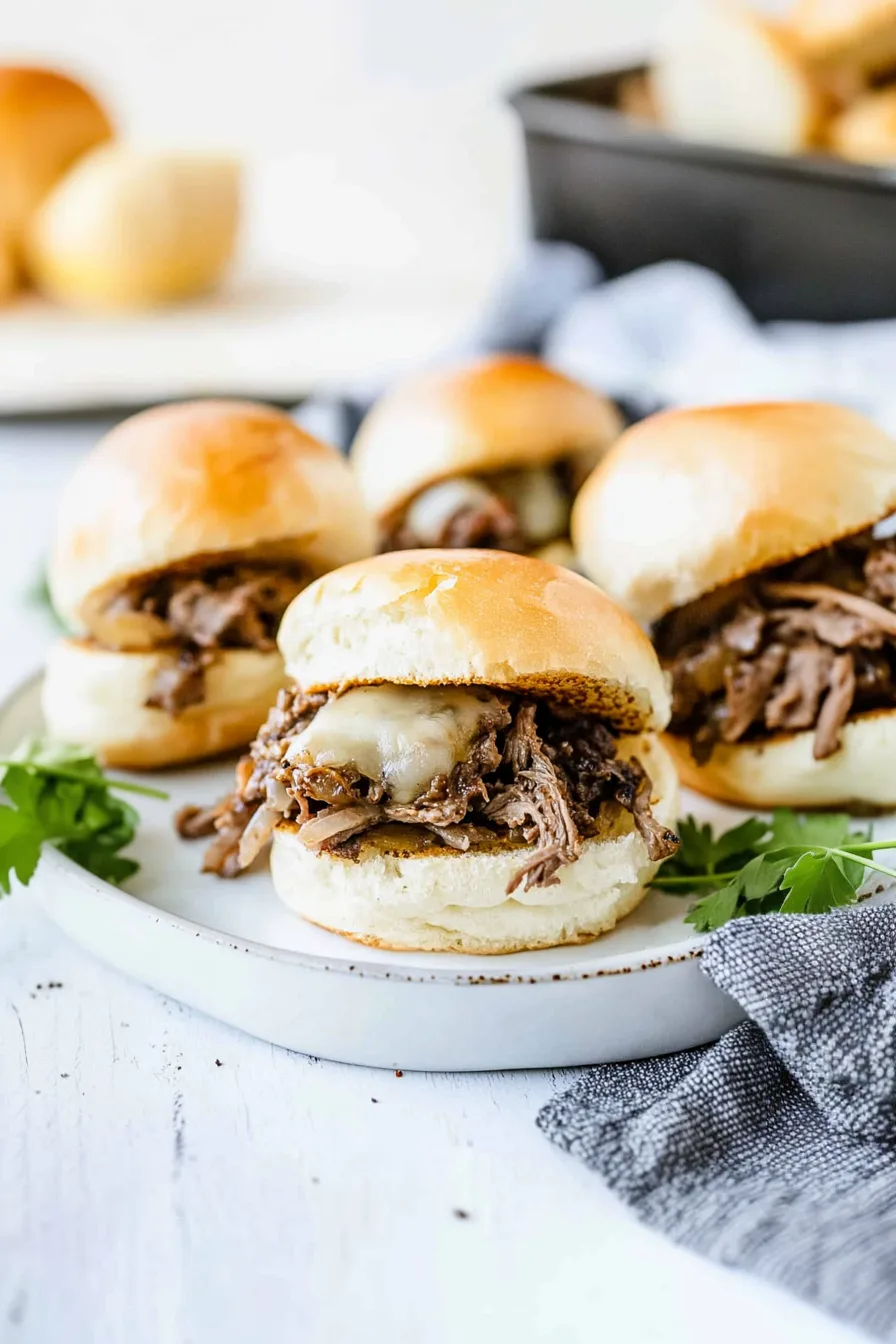Golden baked sliders arranged on a serving tray with melted cheese oozing out.