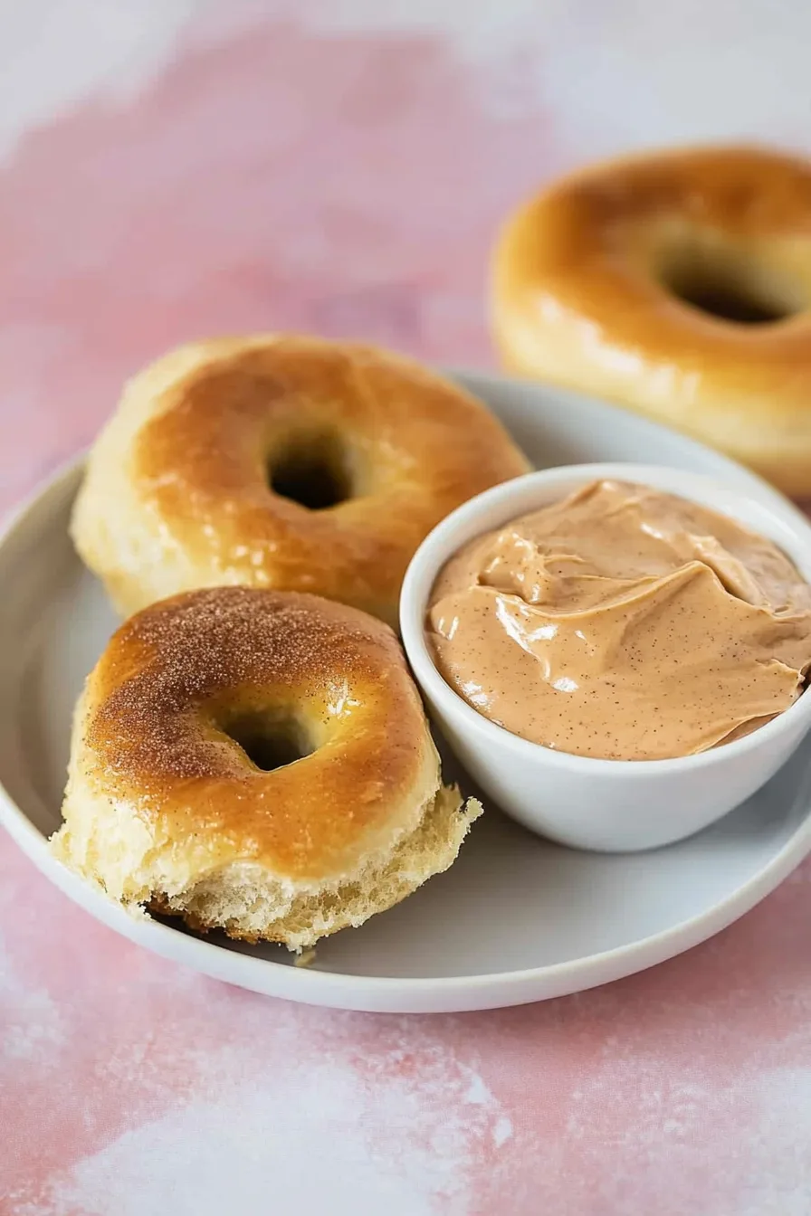 Plate of freshly baked golden dinner rolls served with a side of whipped butter