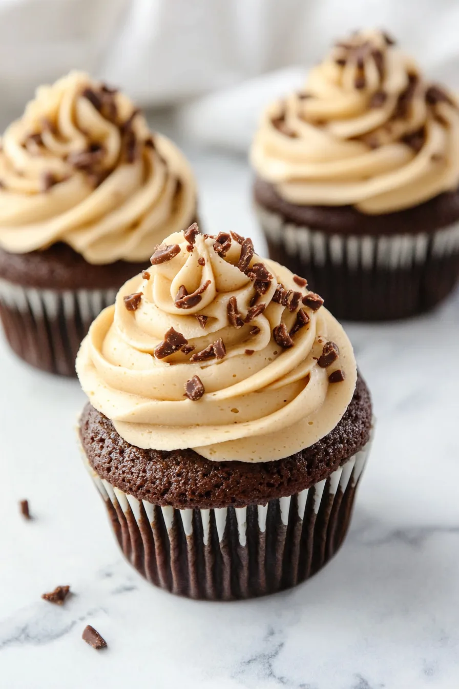 Overhead shot of individual treats with swirled frosting and caramel bits